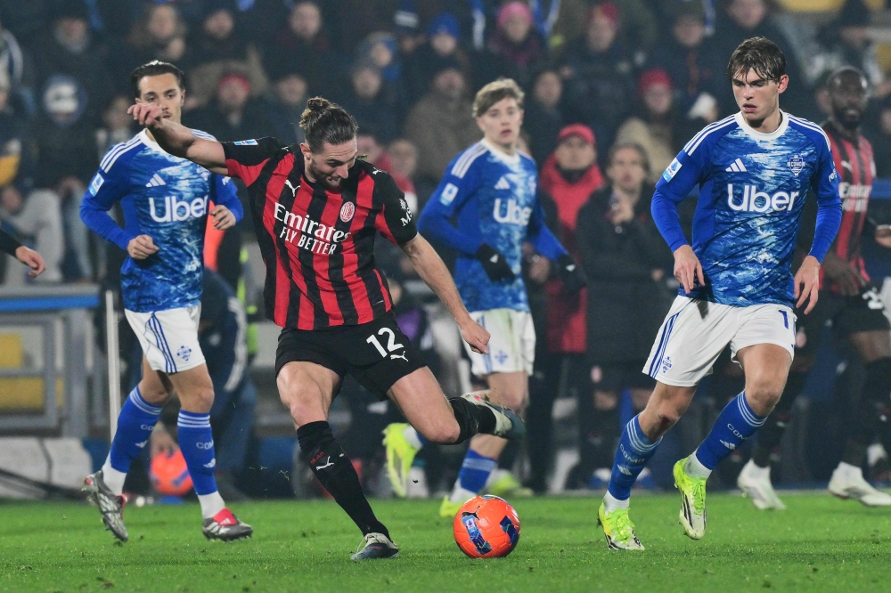 AC Milan's French midfielder #12 Adrien Rabiot shoots to score a goal 