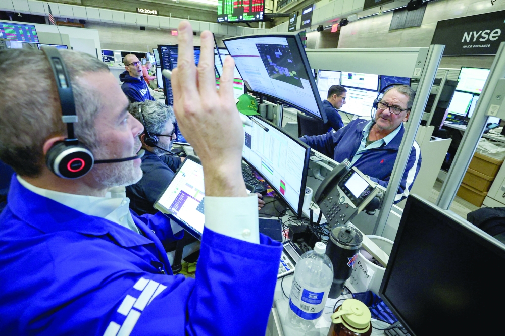 Futures-options traders work on the floor at the New York Stock Exchange's NYSE American (AMEX) in New York City. — Reuters