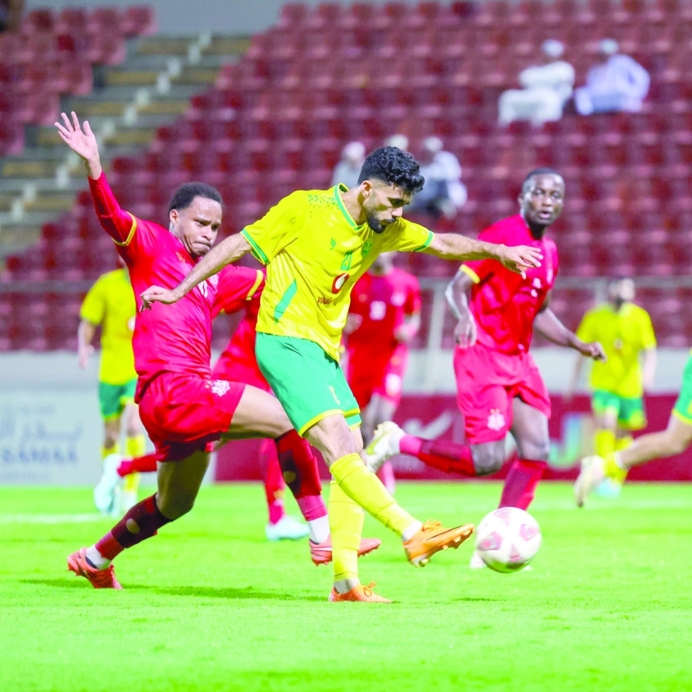 Salah challenges Dhofar defender.