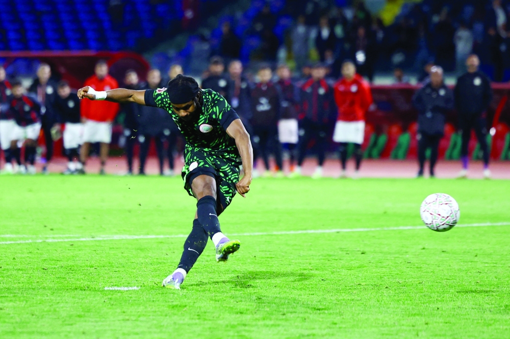 Nigeria's Ademola Lookman scores a penalty during the penalty. — Reuters