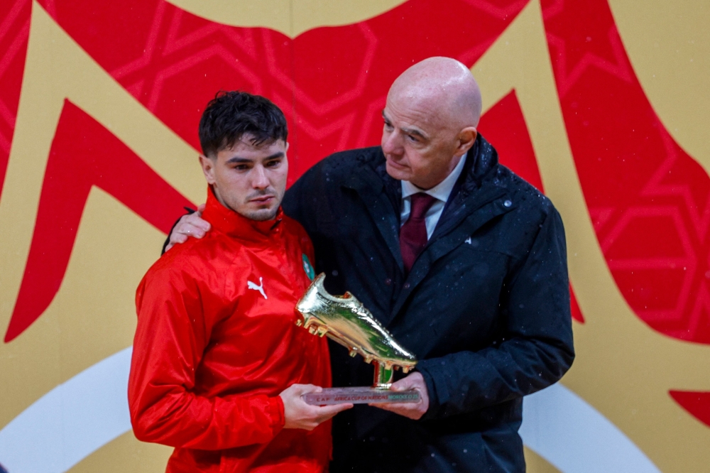 Morocco's forward #10 Brahim Diaz receives the Golden Boot from FIFA President Gianni Infantino 