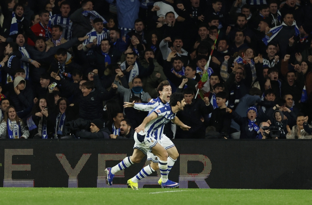  Real Sociedad's Goncalo Guedes celebrates scoring their second goal with teammates  
