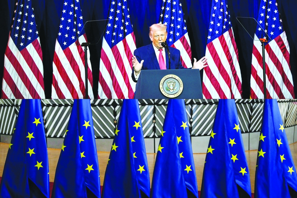 This combination shows US President Donald Trump speaking during the House Republican Party (GOP) member retreat at the Kennedy Center in Washington DC, and a photo of European Union flags in the Europa Building before a summit at the European Council in Brussels. — AFP