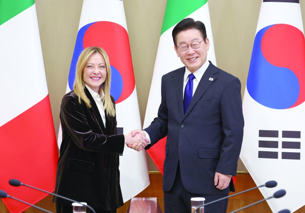 South Korea's President Lee Jae Myung (R) shakes hands with Italy's PM Giorgia Meloni (L) during their meeting in Seoul. — AFP