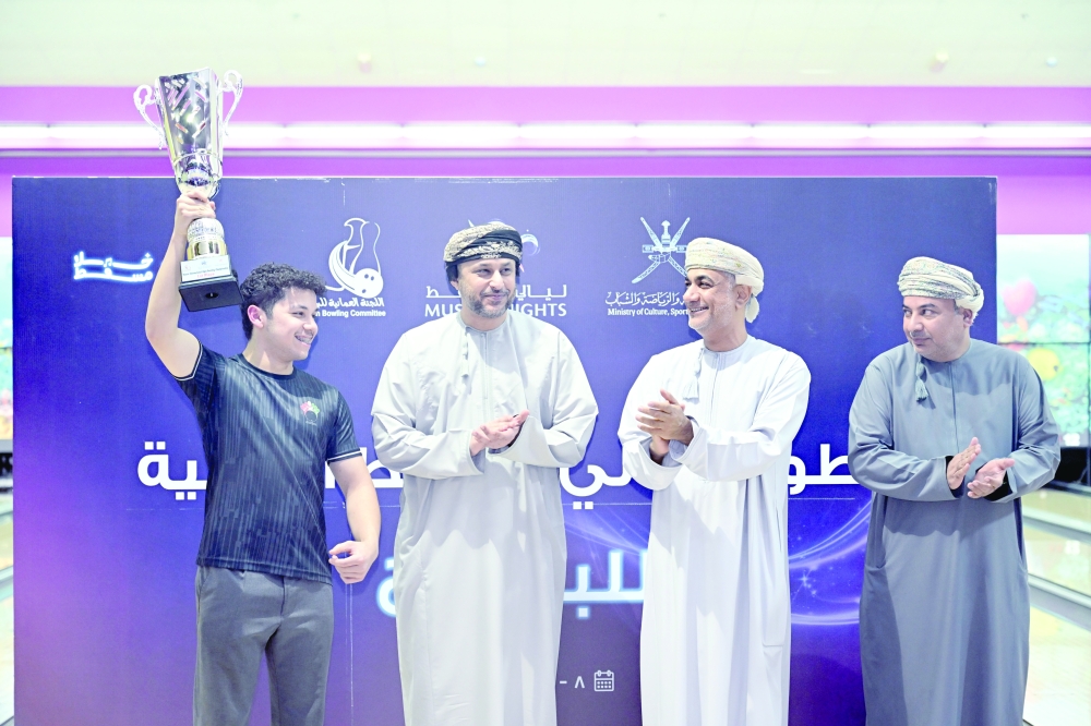 Kuwaiti bowler Nasser al Kandari celebrates with the winner's trophy. — Abdulwahid al Hamadani