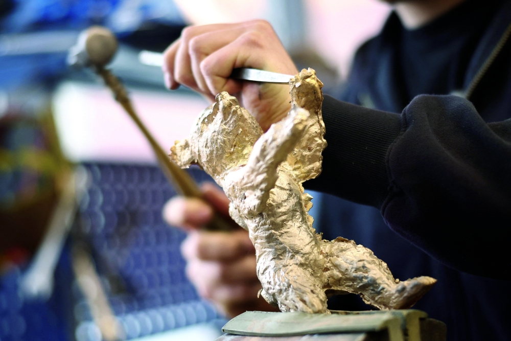 A person works on a Berlin Bear award statuette at the Noack Foundry, during a media tour, ahead of the 76th Berlinale International Film Festival in Berlin. — Reuters