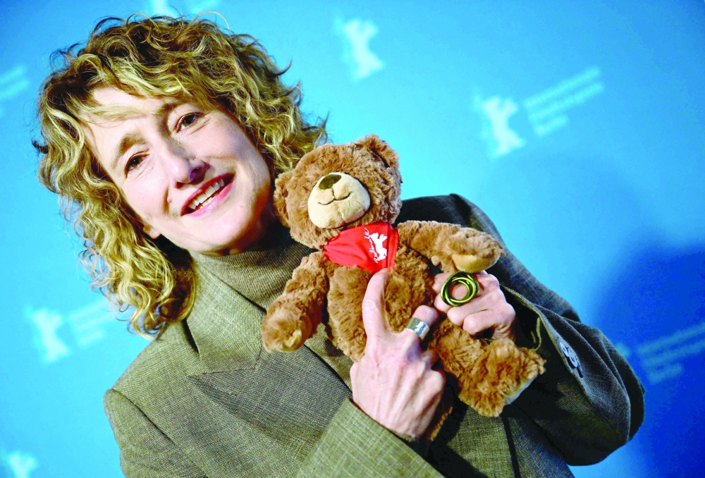 Berlinale director Tricia Tuttle poses with Berlinale merchandise products in Berlin. — AFP