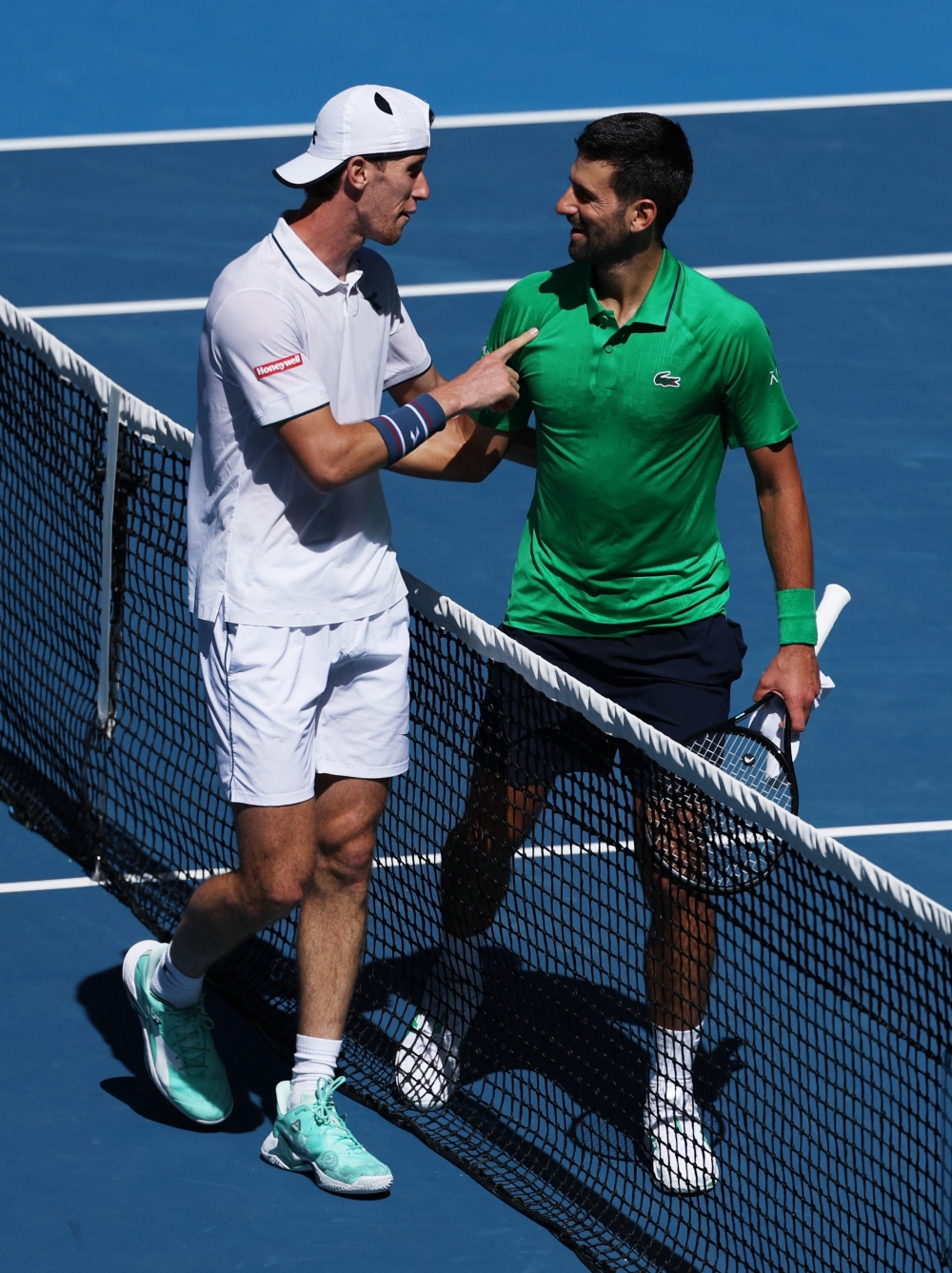 Serbia's Novak Djokovic shakes hands with Italy's Francesco Maestrelli after winning his second round  