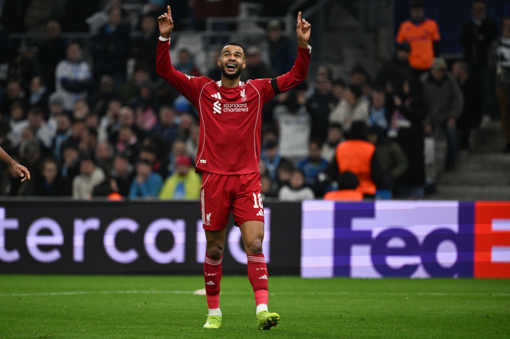 Liverpool's Dutch forward #18 Cody Gakpo celebrates after scoring his team's third goal  