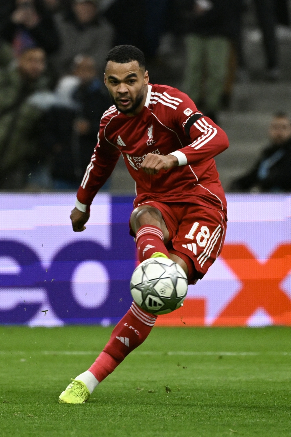 Liverpool's Dutch forward #18 Cody Gakpo shoots to score his team's third goal  