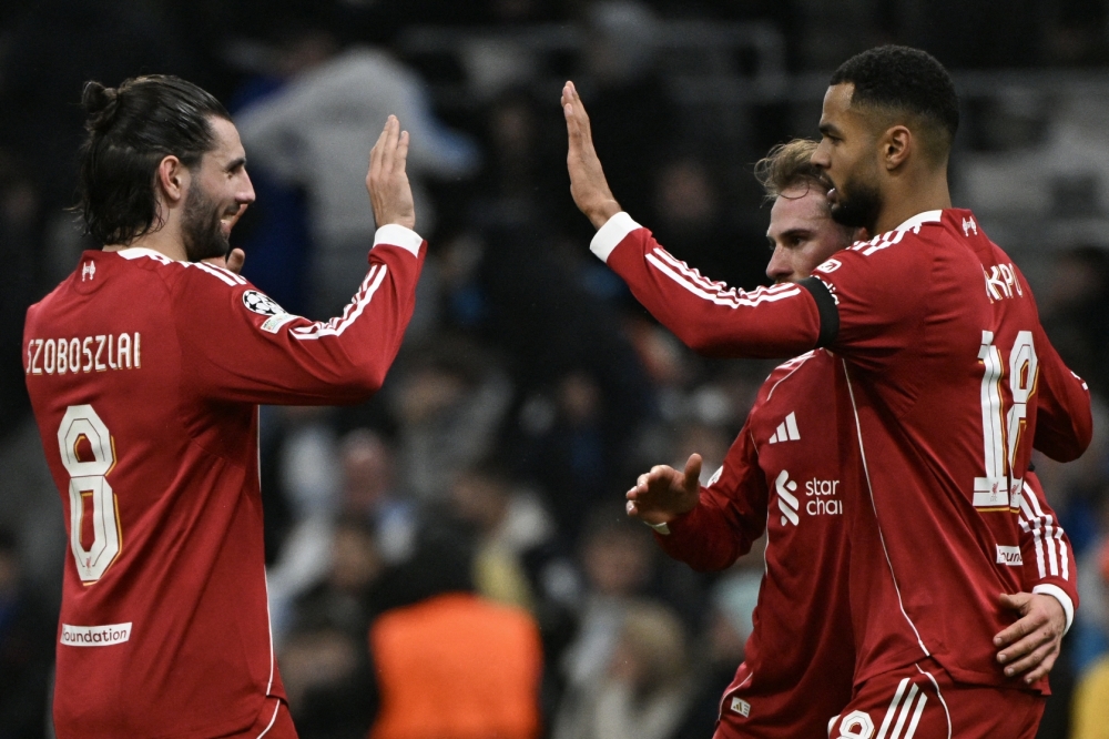 Liverpool's Dutch forward #18 Cody Gakpo (R) celebratres his team's victory with Liverpool's Hungarian midfielder #08 Dominik Szoboszlai (L) 