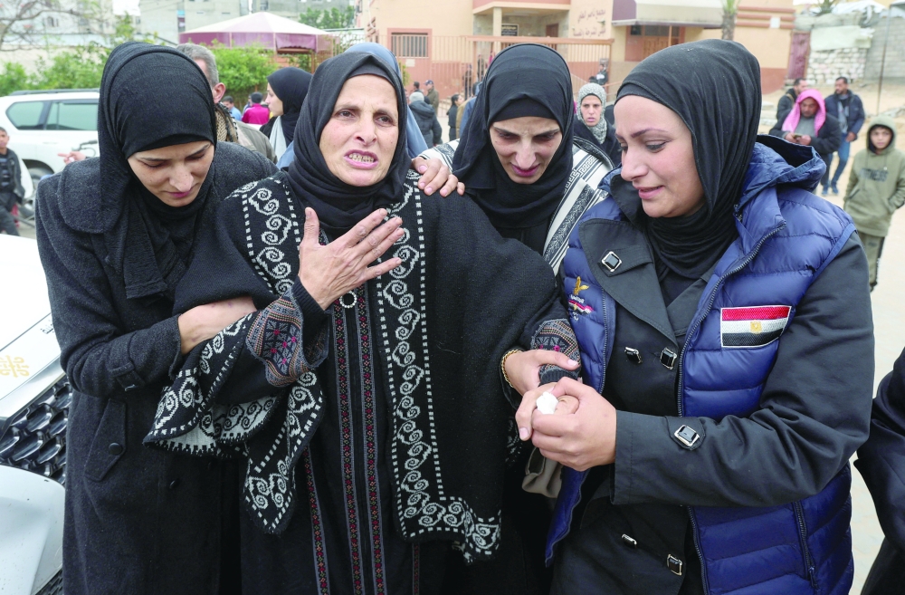 Mourners during the funeral of a Palestinian journalist and employee of the Egyptian Committee killed in an Israeli air strike in Khan Yunis in the southern Gaza Strip. - Reuters