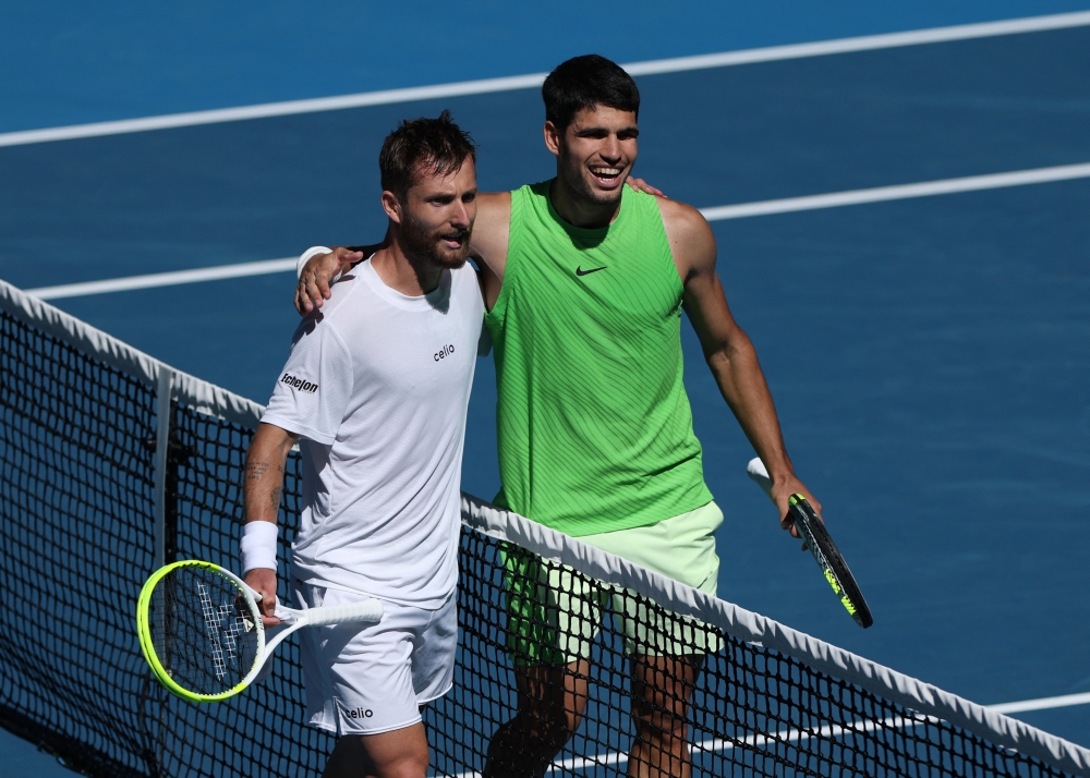  Spain's Carlos Alcaraz with France's Corentin Moutet after winning their third round 