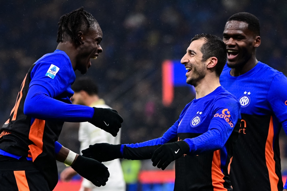 Inter Milan's Armenian  (R) celebrates after scoring his team sixth goal
