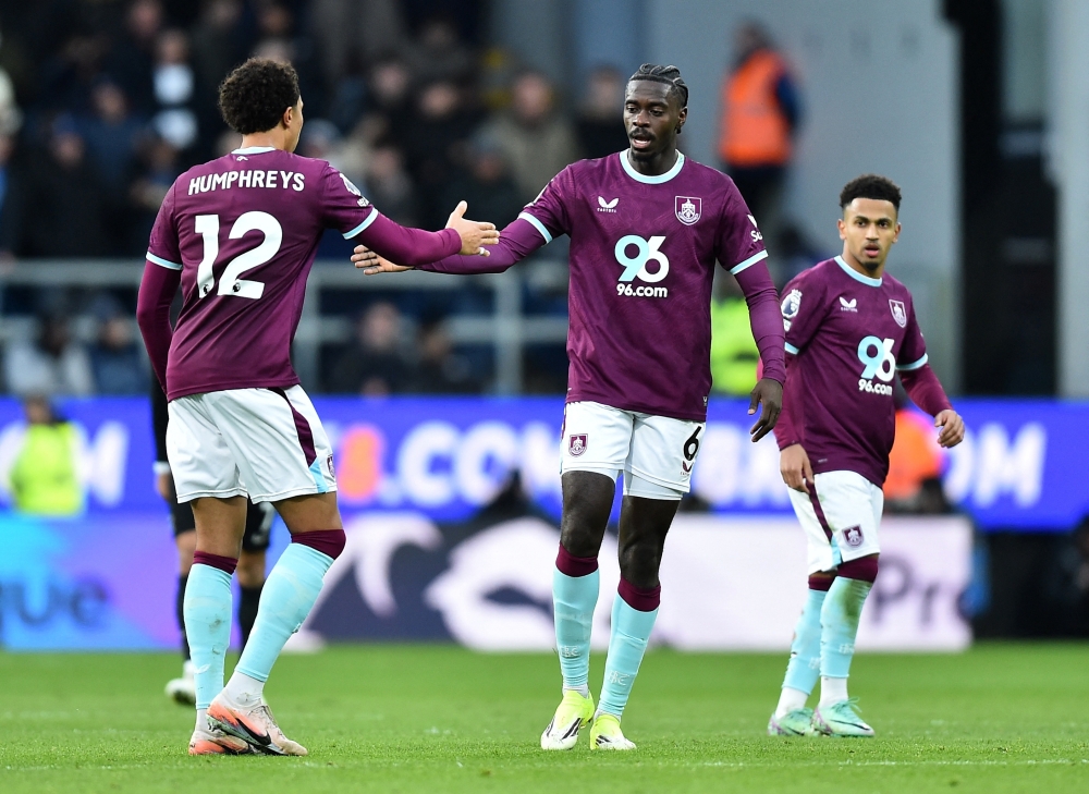   Burnley's Axel Tuanzebe celebrates scoring their first goal with Bashir Humphreys ..