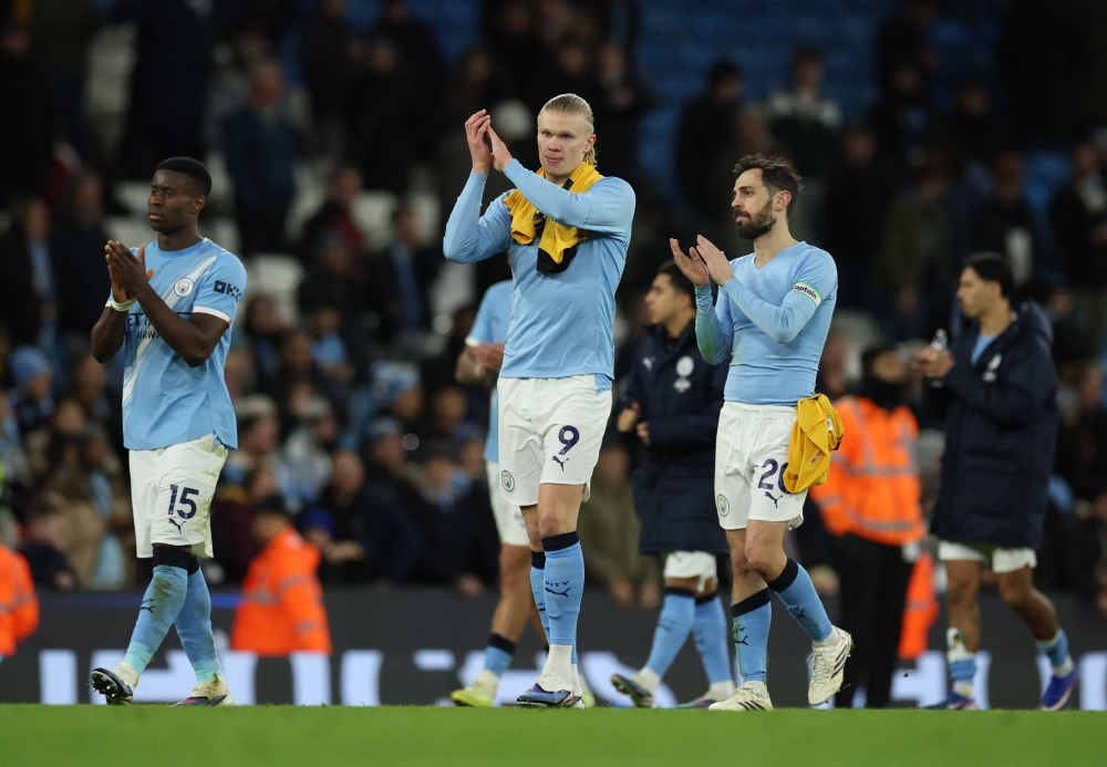 Manchester City's Erling Haaland, Manchester City's Marc Guehi and Manchester City's Bernardo Silva celebrate after the match  