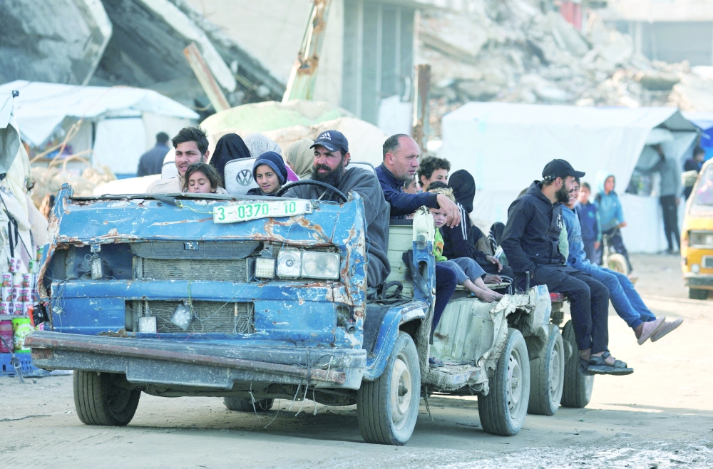 Hussein Liwa, a displaced Palestinian, drives his war-damaged vehicle as he transports residents, in Gaza City, January 25, 2026. REUTERS/Dawoud Abu Alkas  