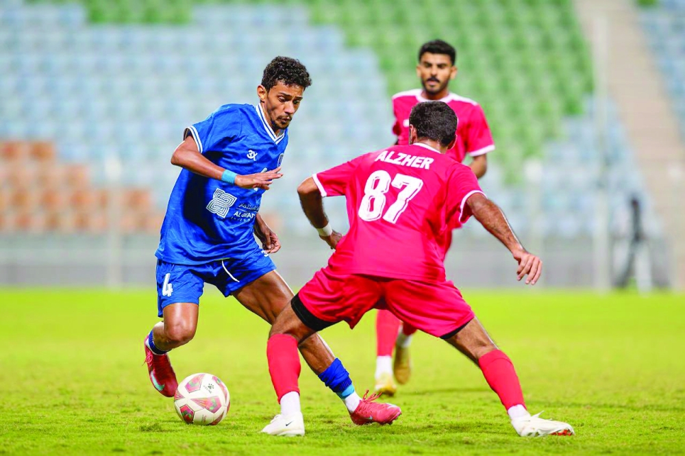 Saham and Oman Club players in action.