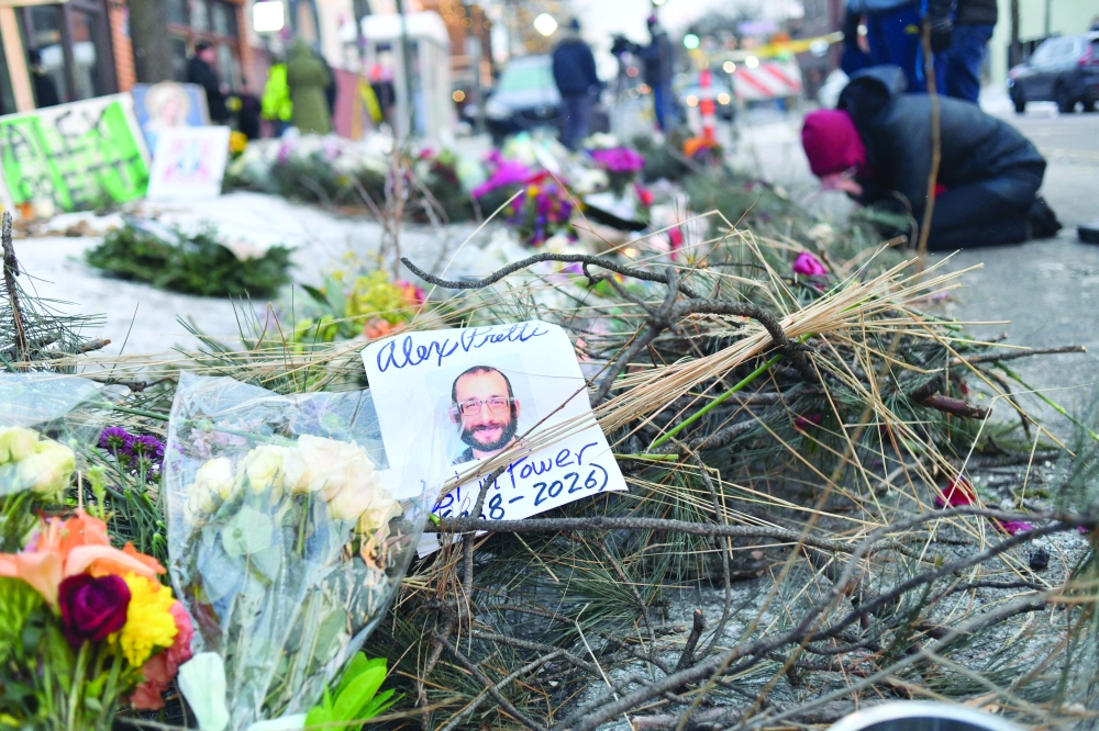 Mourners gather at a makeshift memorial in the area where Alex Pretti was shot dead, in Minneapolis. — AFP