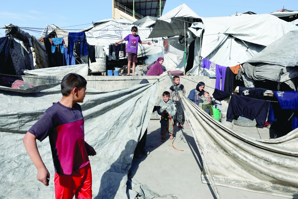 Displaced Palestinian children shelter at a tent camp in Gaza City. — Reuters