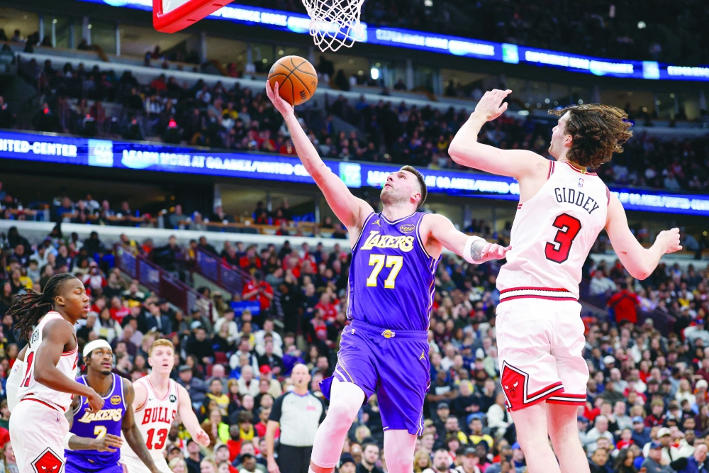 Los Angeles Lakers' Luka Doncic (77) goes to the basket against Chicago Bulls' Josh Giddey (3) at United Center. — Imagn Images