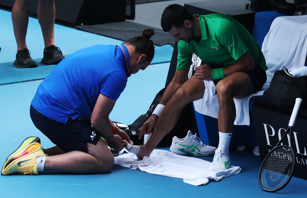  Serbia's Novak Djokovic receives medical attention during his quarter final match  