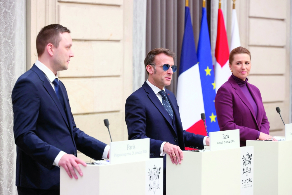French President Emmanuel Macron (C) Denmark PM Mette Frederiksen (R) and Greenland PM Jens-Frederik Nielsen (L) give a press conference at the Elysee Palace.  