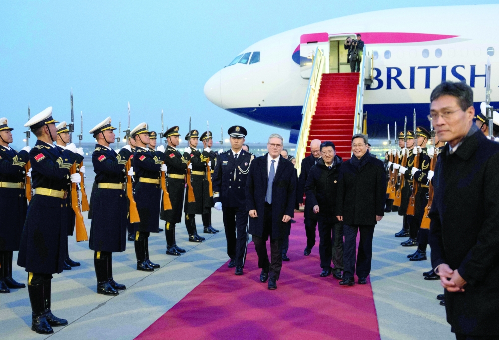 Britain’s PM Keir Starmer is welcomed upon his arrival at an airport in Beijing. 