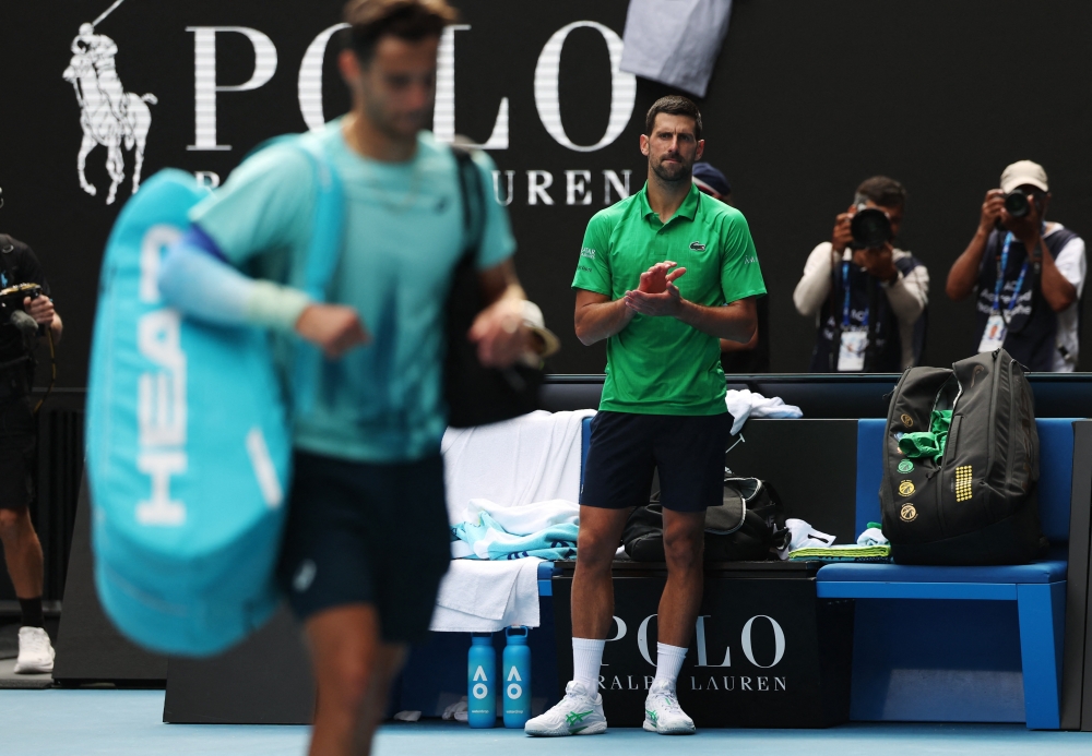  Serbia's Novak Djokovic applauds for Italy's Lorenzo Musetti 