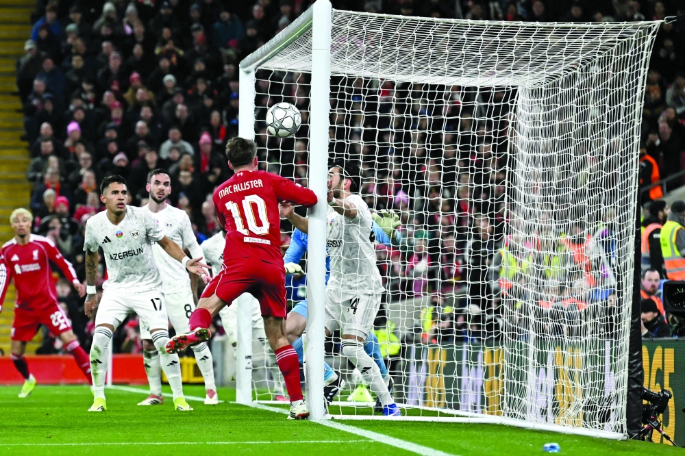 Liverpool's Argentinian midfielder #10 Alexis Mac Allister scores the team's first goal during the UEFA Champions League football match between Liverpool and Qarabag at Anfield in Liverpool, north west England on January 28, 2026.  (Photo by Paul ELLIS / AFP)
