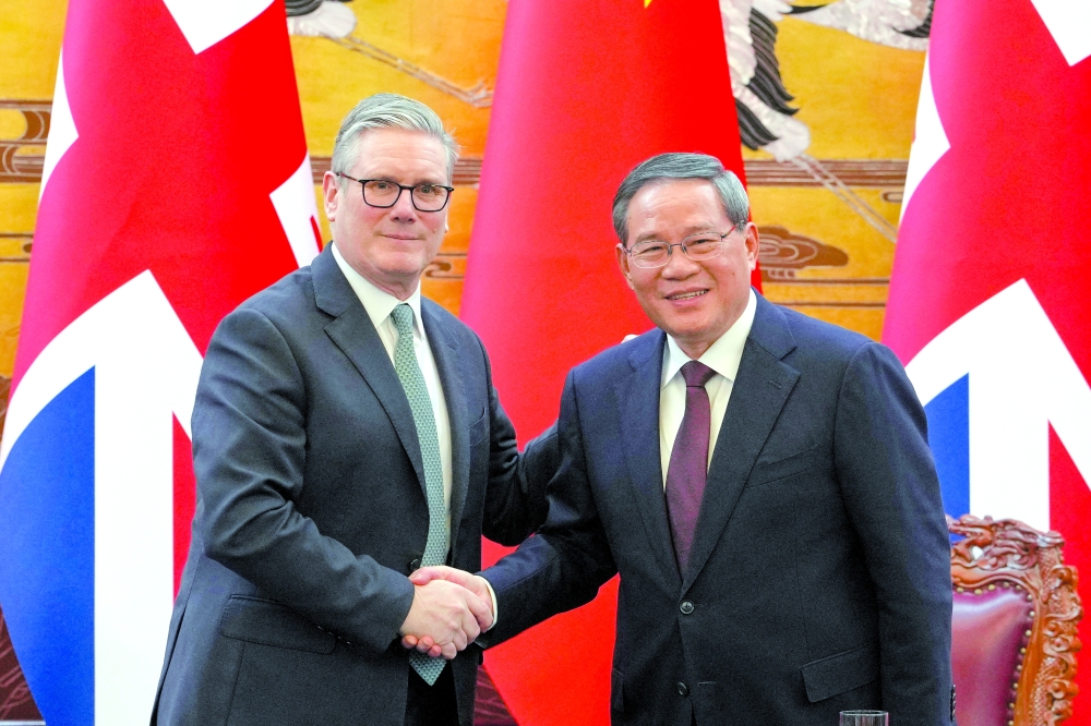 Britain's Prime Minister Keir Starmer and Chinese Premier Li Qiang after a signing ceremony held at the Great Hall of the People in Beijing. - Reuters