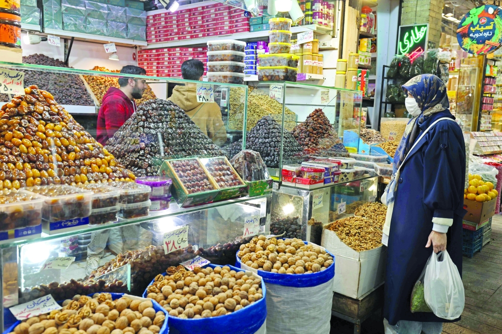 A woman shops for dry fruits at a store in Tajrish Bazaar, in Tehran, on Thursday. — AFP