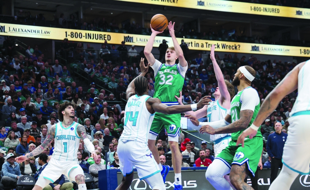 Dallas Mavericks forward Cooper Flagg (32) shoots over Charlotte Hornets forward Moussa Diabate (14) during the second half at American Airlines Center 