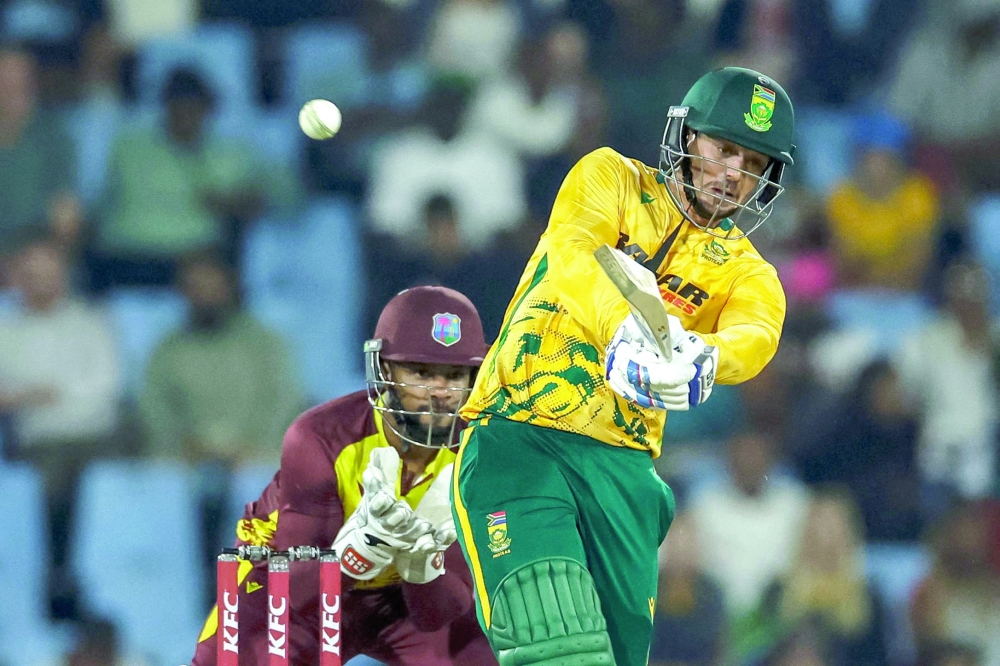 South Africa's Quinton de Kock (R) hits a six during the second Twenty20 international cricket match between South Africa and West Indies 