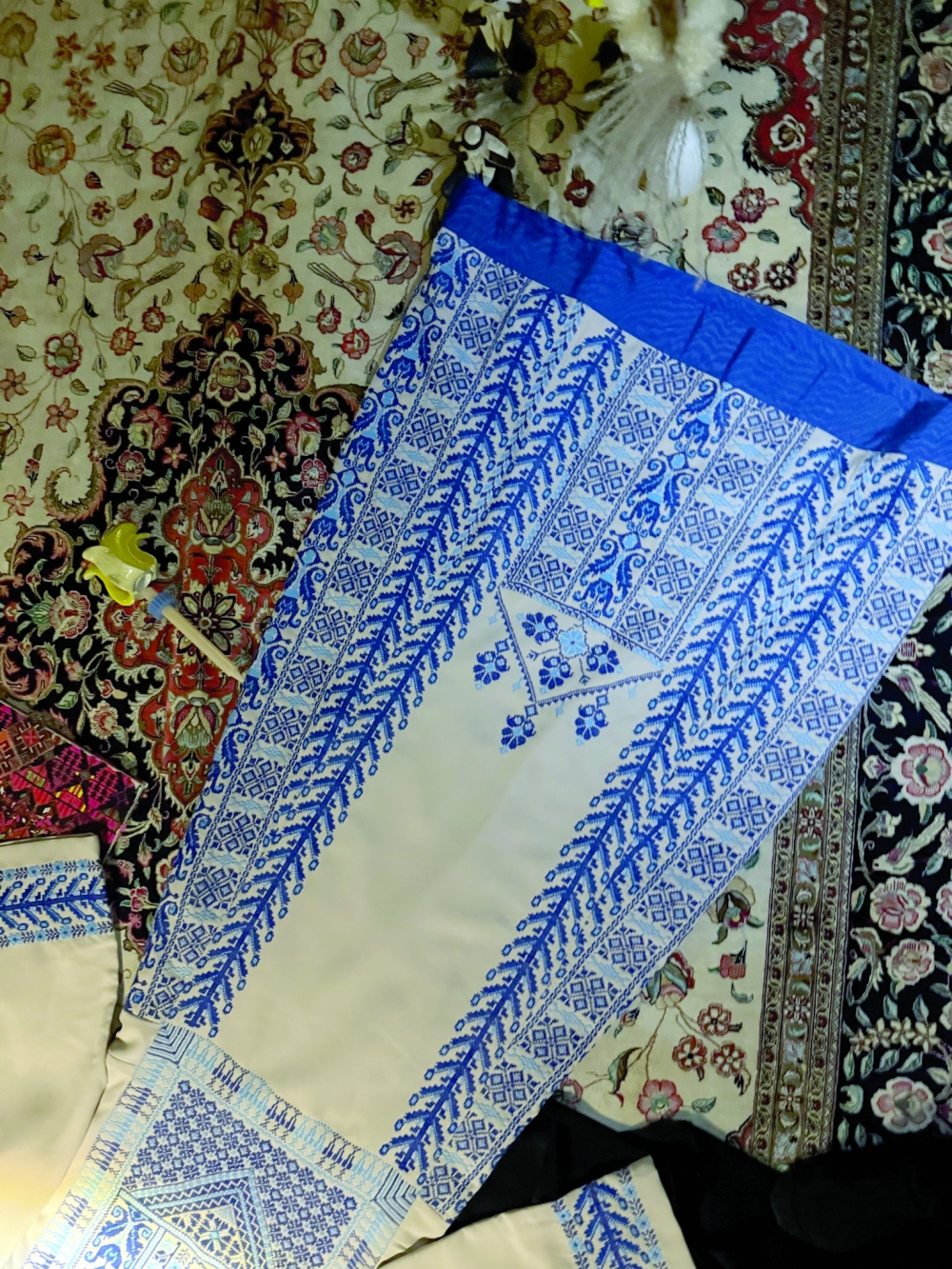 hand images of embroidered pieces made by our team