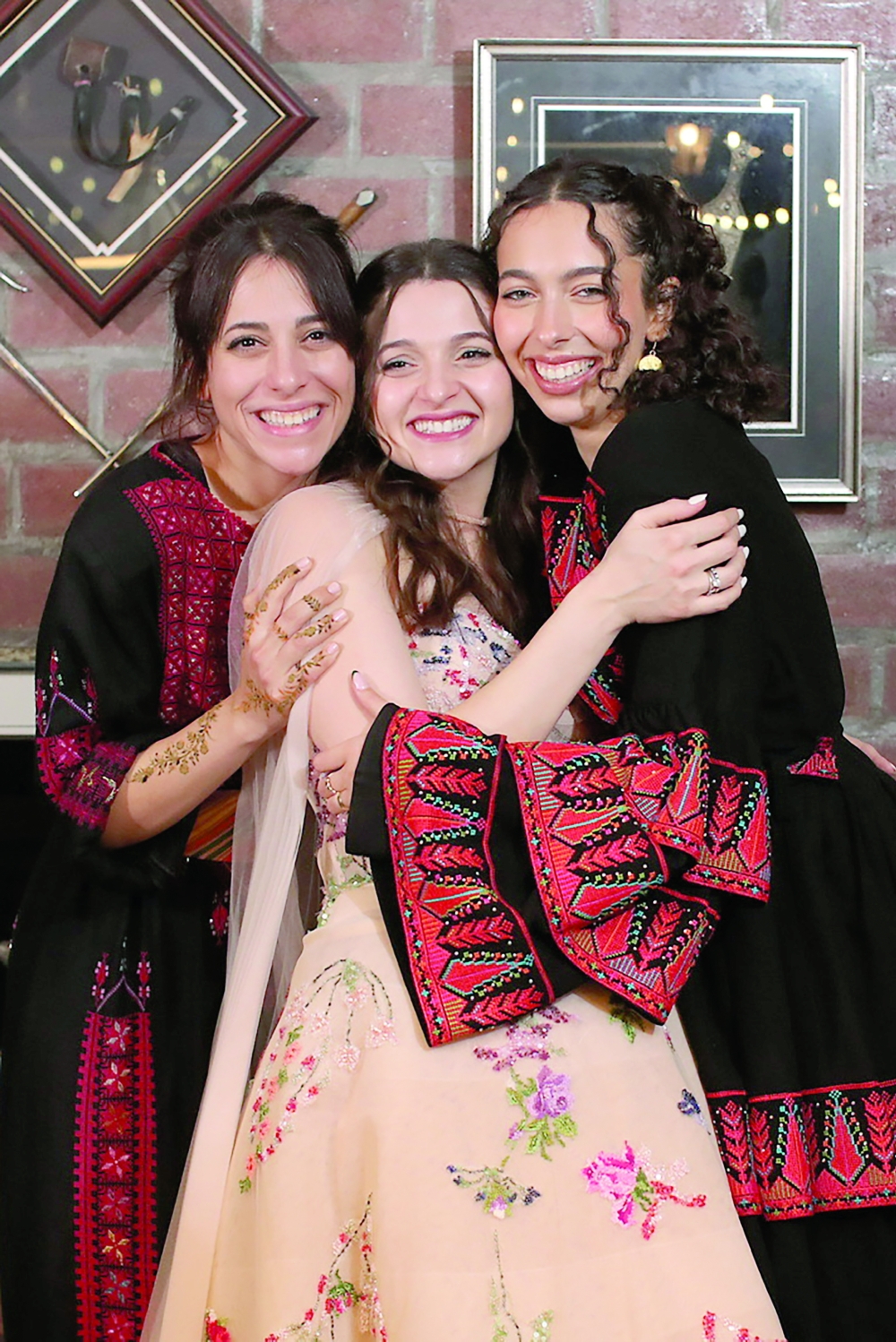 Palestinian sisters Meera, Yara and Tala Alul in traditional Palestinian attire