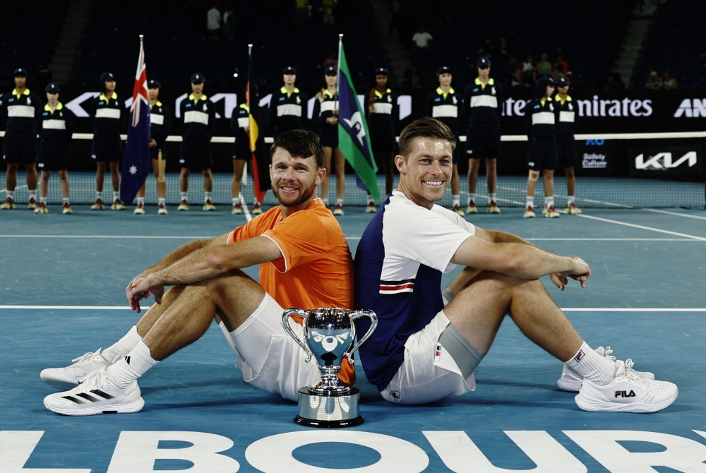 Christian Harrison of the U.S. and Britain's Neal Skupski pose with the trophy 