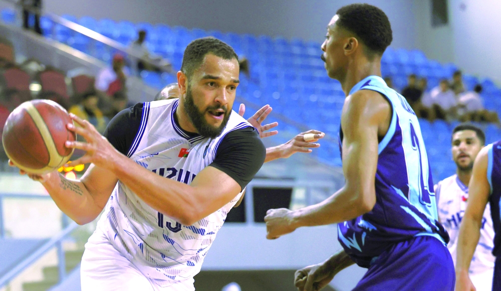 A player from the Nizwa team tries to get past a player from Salalah team.