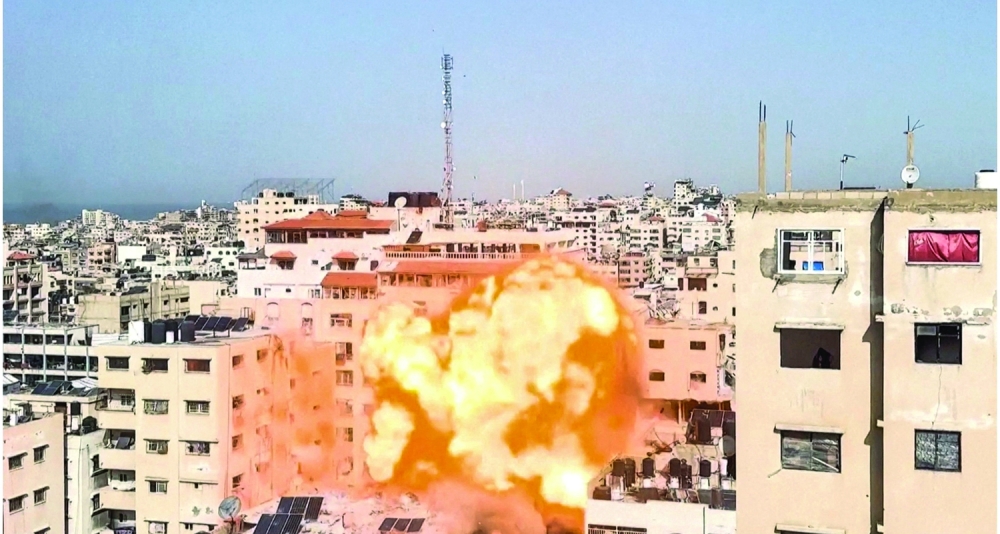 A screengrabs from a video obtained by Reuters shows a projectile falling, an explosion and smoke rising during an Israeli airstrike on a building in Gaza City. - Reuters