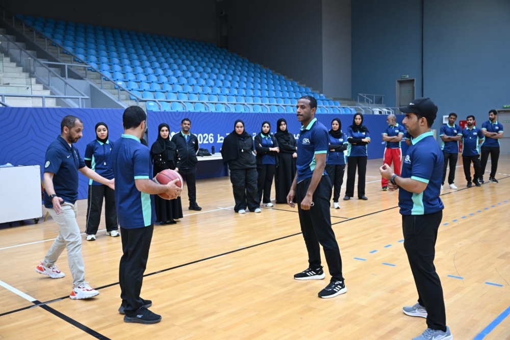 Participants gather on court for practical drills, applying officiating mechanics and positioning techniques under the guidance of the camp instructor. — Khalfan al Ruzaiqi
