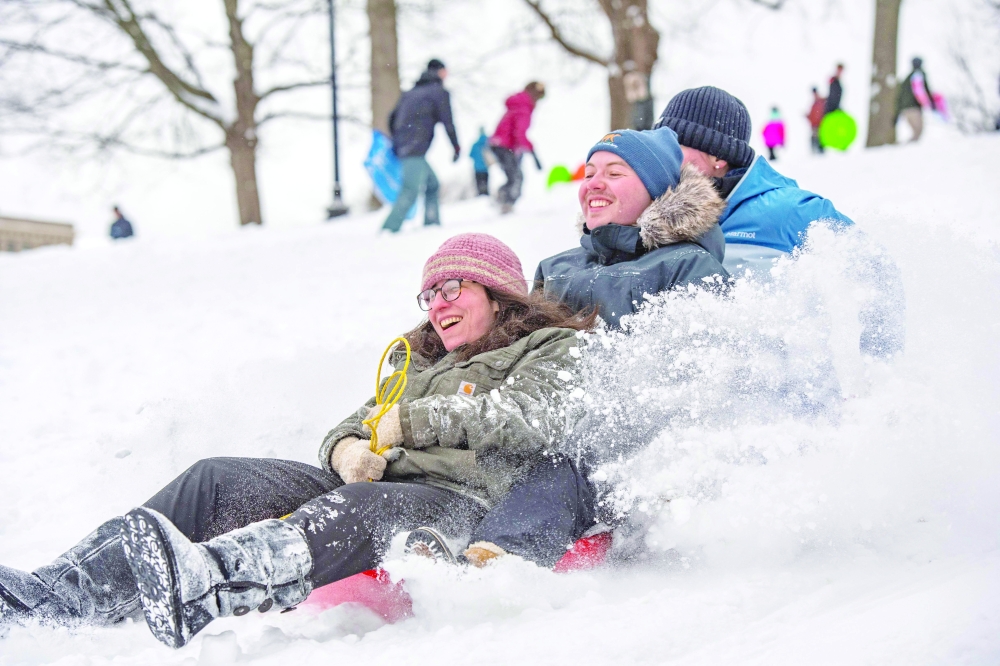 People sled down Flagstaff Hill in Boston Common after a snowstorm in Boston, Massachusetts. - AFP  