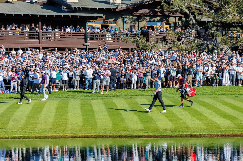 Justing Rose waves to the crowd on the 18th hole during the final round  