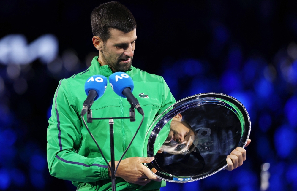  Serbia's Novak Djokovic with the runners up trophy after losing the Australian Open men's singles