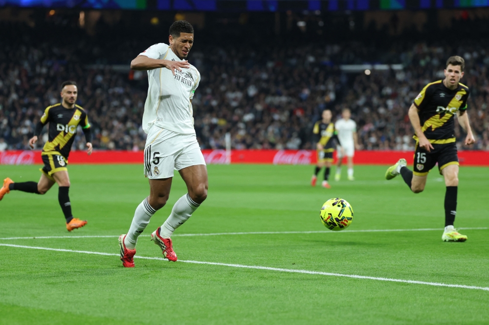 Real Madrid's English midfielder #05 Jude Bellingham reacts to getting injured 