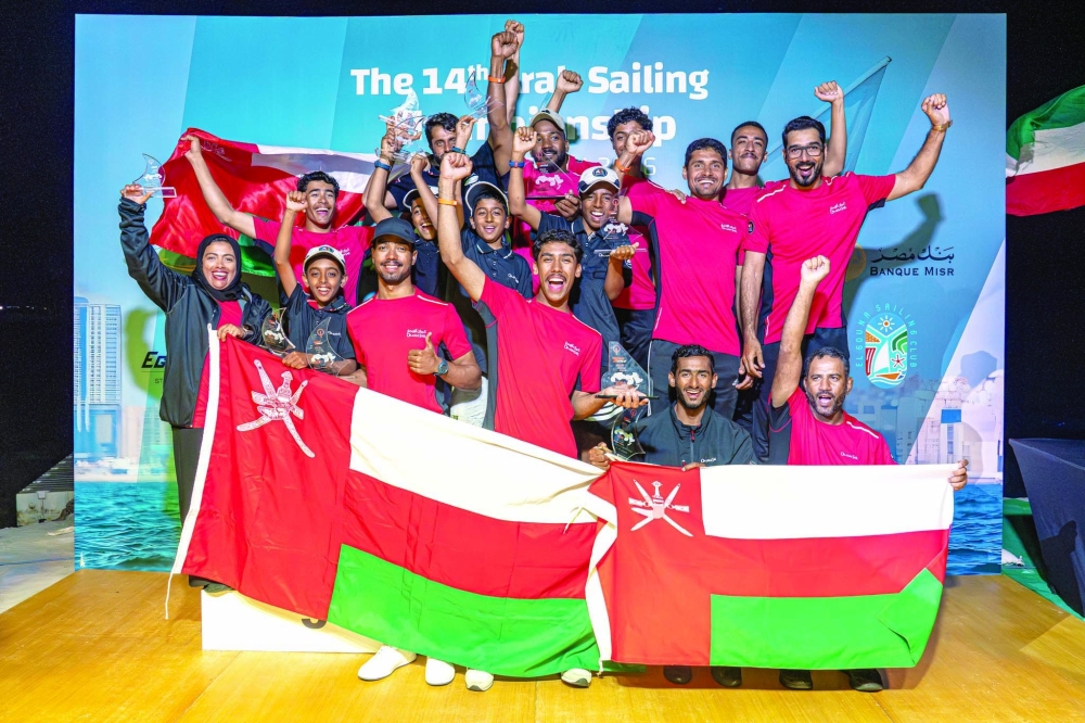 Omani sailors celebrate with the medals.