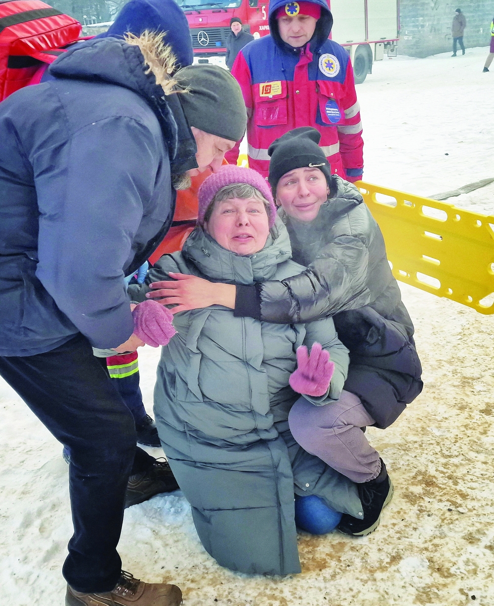 Residents react at the site of the apartment building hit by a Russian drone strike in Kharkiv, Ukraine on Tuesday. — Reuters