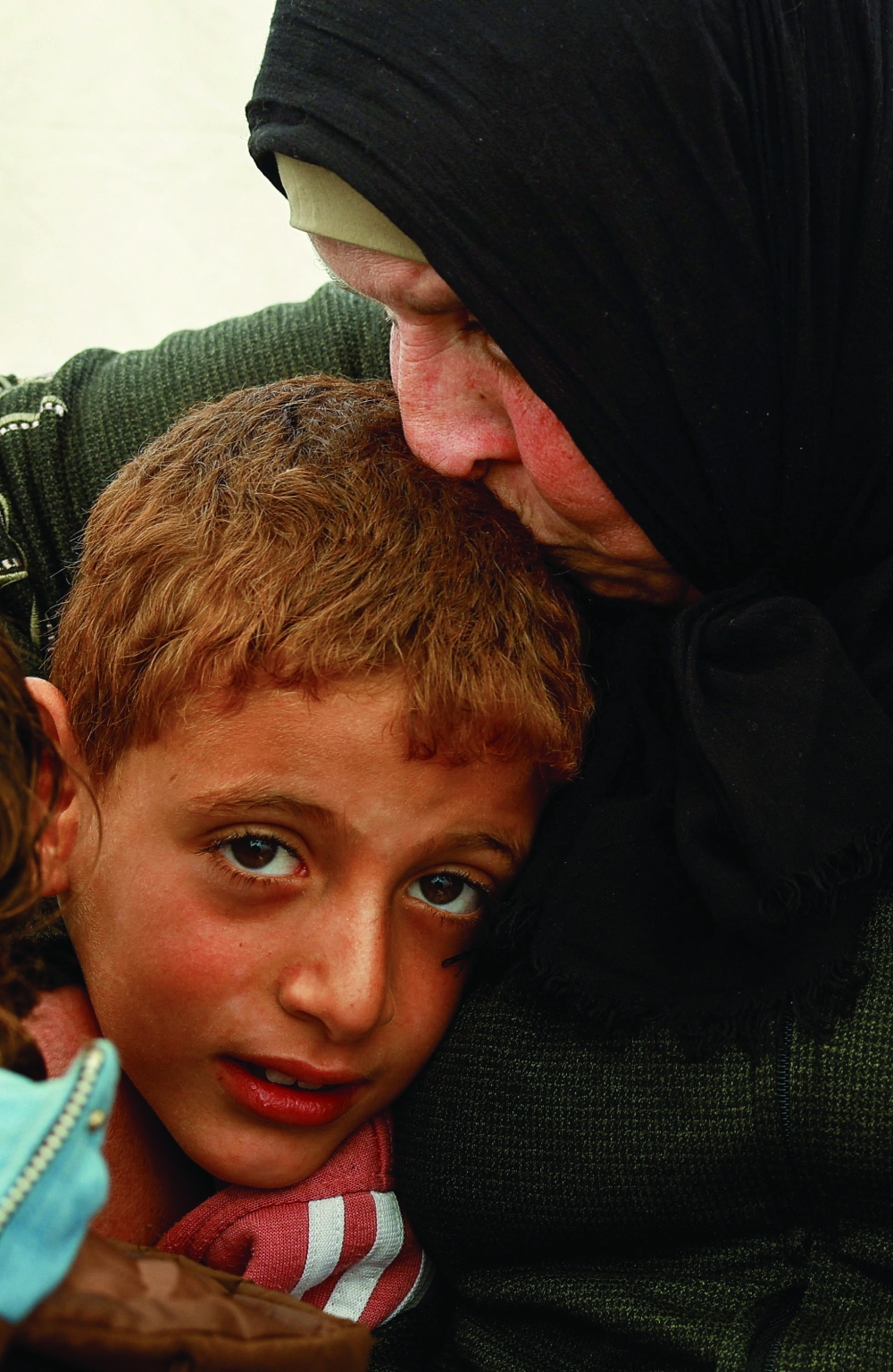 Huda Abu Abed with her grandson at a tent shelter after returning to Gaza through the Rafah crossing, in Khan Yunis in the southern Gaza Strip, on Tuesday. - Reuters
