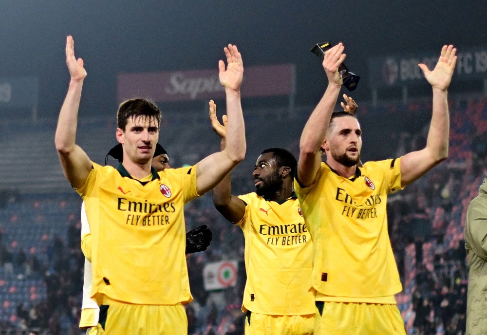 AC Milan's Matteo Gabbia and Adrien Rabiot applaud fans