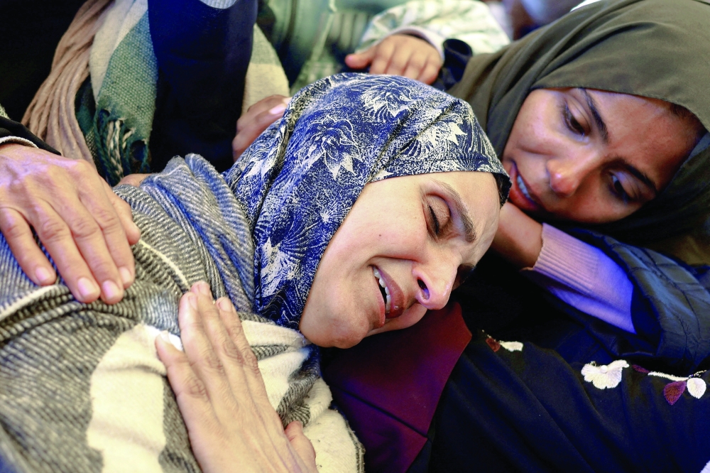 Mourners react during the funeral of Palestinians killed on Wednesday in an Israeli strike in the southern Gaza Strip