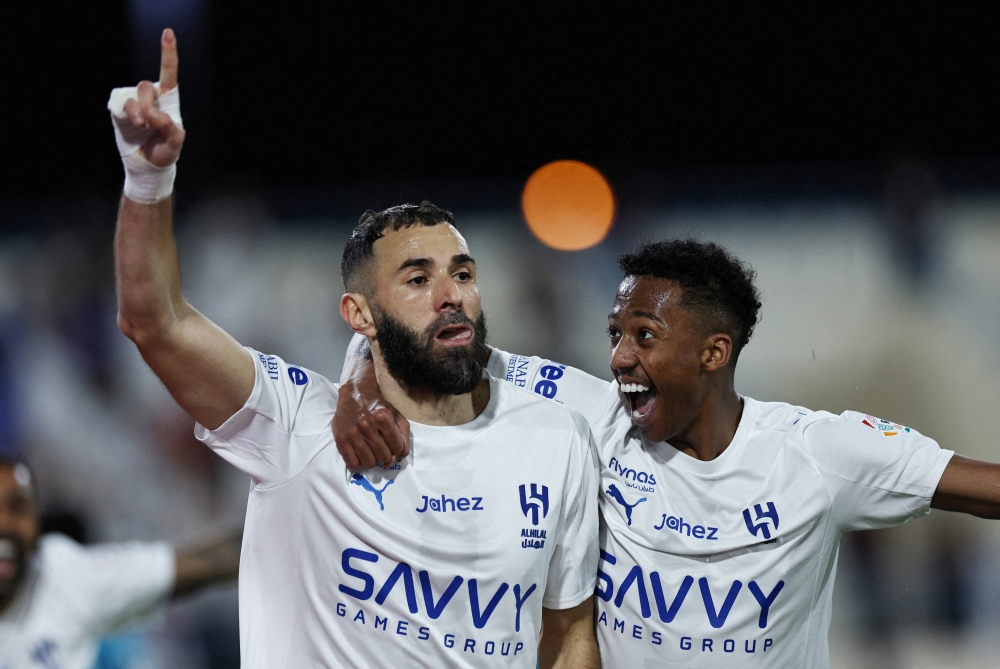  Al Hilal's Karim Benzema celebrates scoring their first goal with Nasser Al Dawsari 